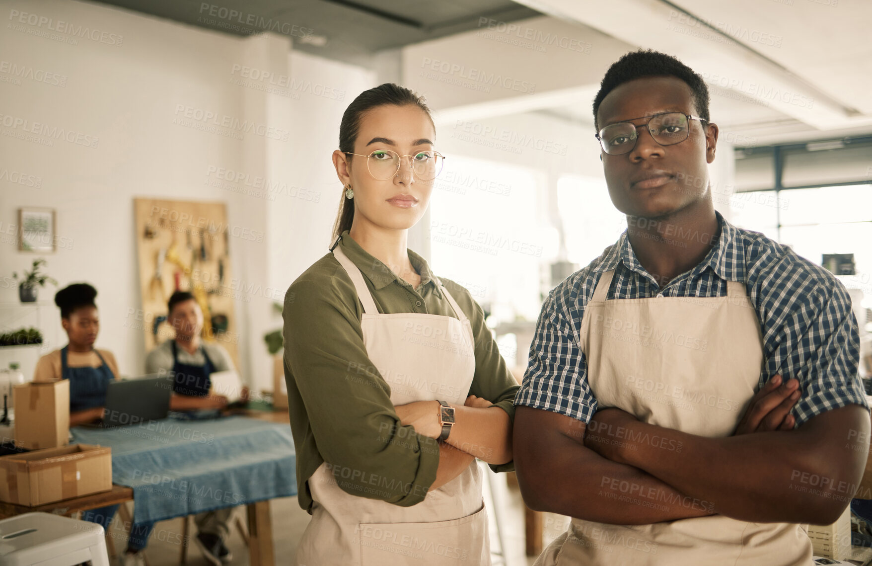 Buy stock photo Fashion, design and style with two diverse and professional team members standing arms crossed and working in a creative workshop. Serious and confident textile workers in a small business startup