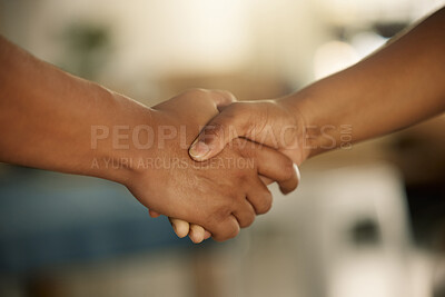 Teamwork, trust and support between a colleague, coworker or business partner. Closeup of two people sharing a hand shake. Professional manager welcoming, promoting or congratulating an employee