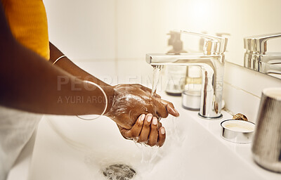 Washing, cleaning and keeping hands clean with water and soap in the bathroom to protect, keep safe and lower risk of getting sickness, illness or disease. Person doing routine hygiene and grooming