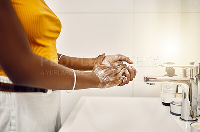 Woman washing, cleaning and rubbing hands with soap and water for good personal hygiene, safety and health in a bathroom at home. Killing germs, virus and bacteria to prevent the spread of infection