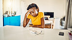 Stressed, tired and frustrated African student sitting in her room thinking about stressful problems. Depressed, anxious and exhausted female worried about sad news in her house