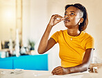 Woman testing for virus, disease and illness during covid pandemic at home. One sick, ill and black female using a self medical test kit to check for sickness on a table or counter alone at home