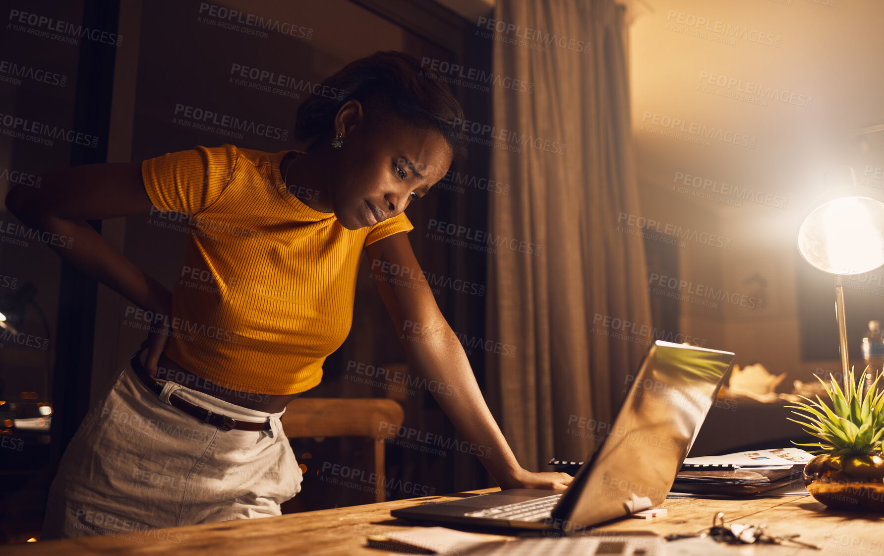 Buy stock photo Back pain of stressed, tired and confused student, learning and studying on laptop late at night at home. Unhappy, depressed or upset woman with backache struggling to finish evening school deadline