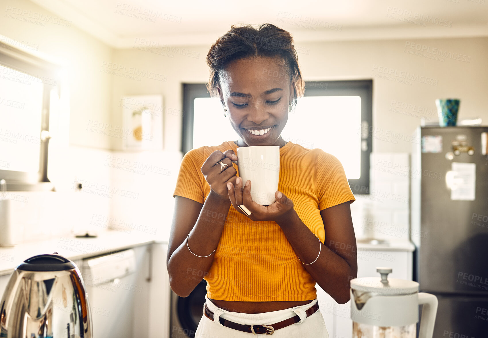 Buy stock photo Beautiful, happy and relaxed woman with coffee cup in the morning after waking up on weekend at home. Young woman smiling, looking and enjoying hot mug of tea or a comforting warm drink in a kitchen