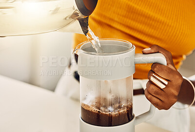 Closeup female hands making coffee for breakfast in the morning using hot water from kettle in a kitchen or cafe. Housewife or hostess brewing tea or espresso beverage for guest or home visitor.