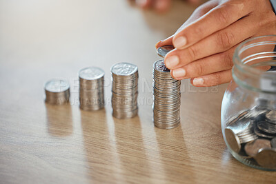Investment, profit and finance concept of coins on a table in lines, rows and stacks of silver change, currency and money. Hand counting, stacking and holding silver on surface for budget and banking