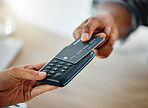 Customer shopping with credit card money and paying using digital nfc technology while buying in a store. Closeup of two hands making a finance, online banking or consumerism transaction from above