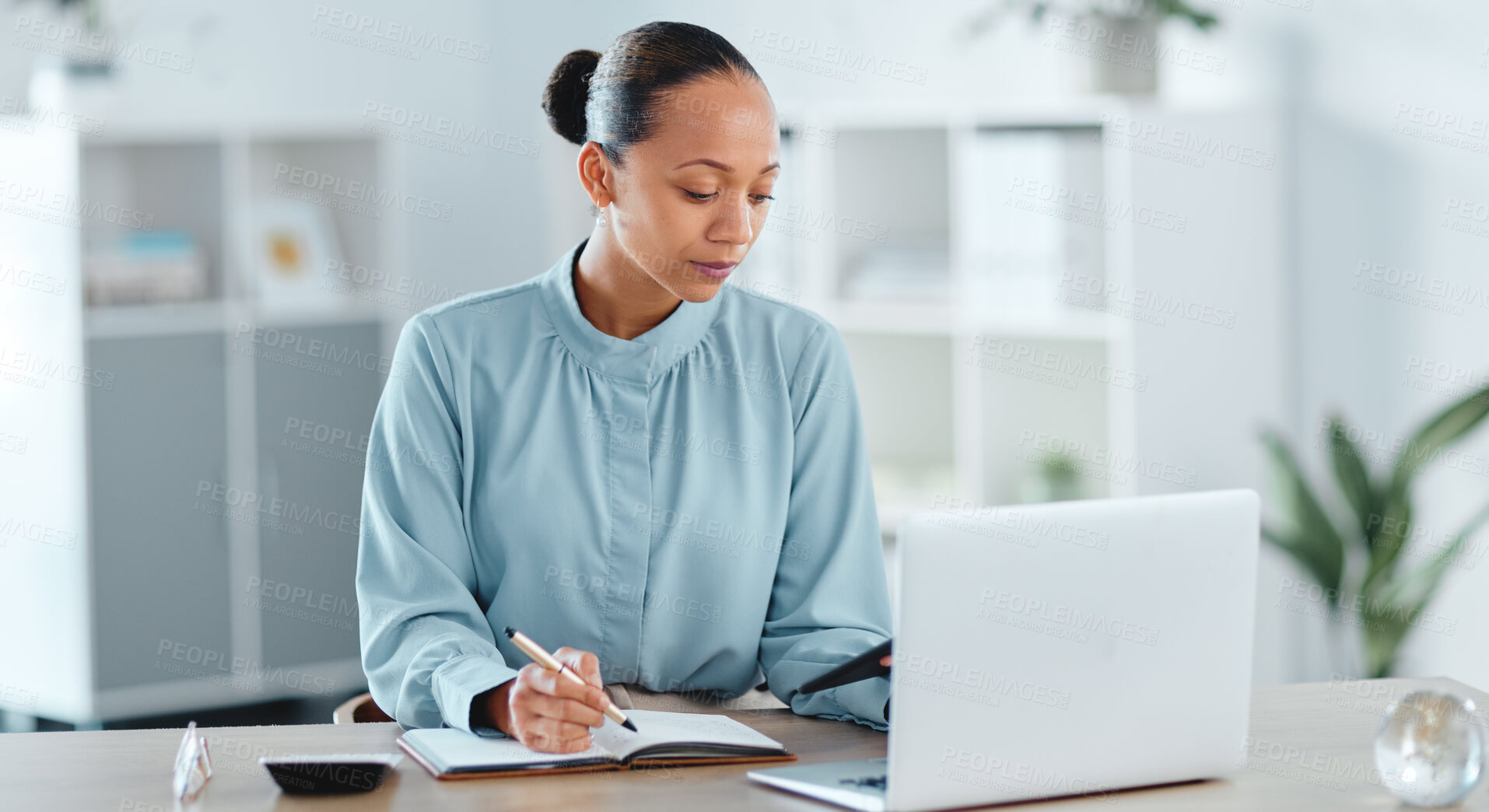 Buy stock photo Busy, smart and serious business manager with a laptop working on schedule, planning and brainstorming ideas inside office. Lady marketing analyst writing strategy for project plan in her diary