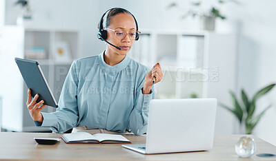 Serious and confident call center agent calling, helping and assisting a deal or sale on laptop and tablet. Focused, successful and motivated freelance support staff multitasking to help customer