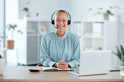 Happy and confident call center agent sitting in front of a laptop while wearing a headset in an office. Portrait of a happy saleswoman using web chat to assist customer sales and service support