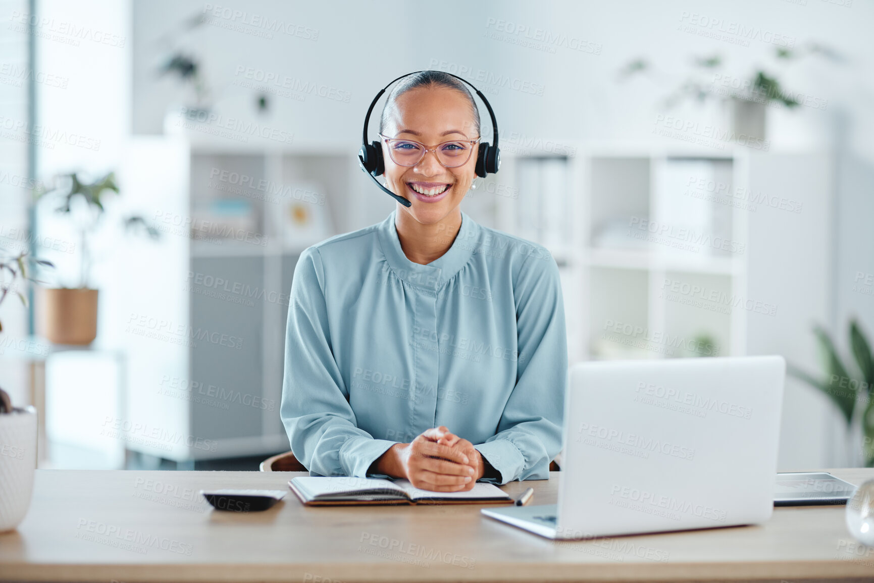 Buy stock photo Happy and confident call center agent sitting in front of a laptop while wearing a headset in an office. Portrait of a cheerful saleswoman using web chat to assist customer sales and service support