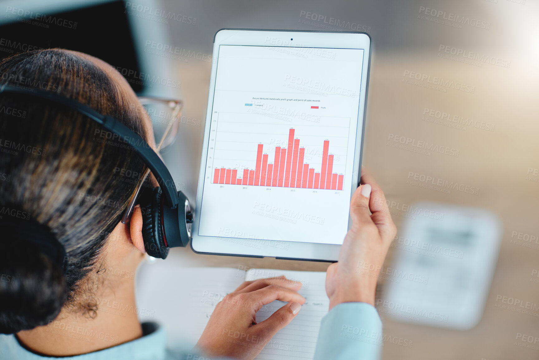 Buy stock photo Financial advisor reading, studying and checking finance data charts, graphs and reports on tablet in office. Above view of agent holding, analyzing and sharing profit or loss information with client