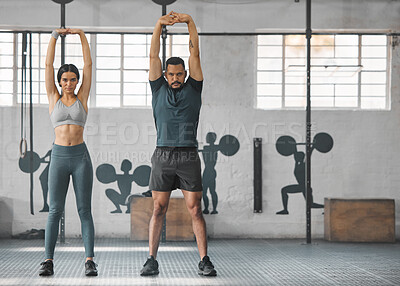 Fitness, active and healthy couple stretching, exercising or training together inside gym. Two young fit trainer doing a full body workout exercise or warmup routine in the day time with copy space