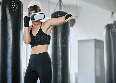 Buy stock photo Healthy, fit and active boxing woman with a VR headset to access the metaverse while exercising, training and working out in a gym. Female boxer doing a workout in virtual reality with technology