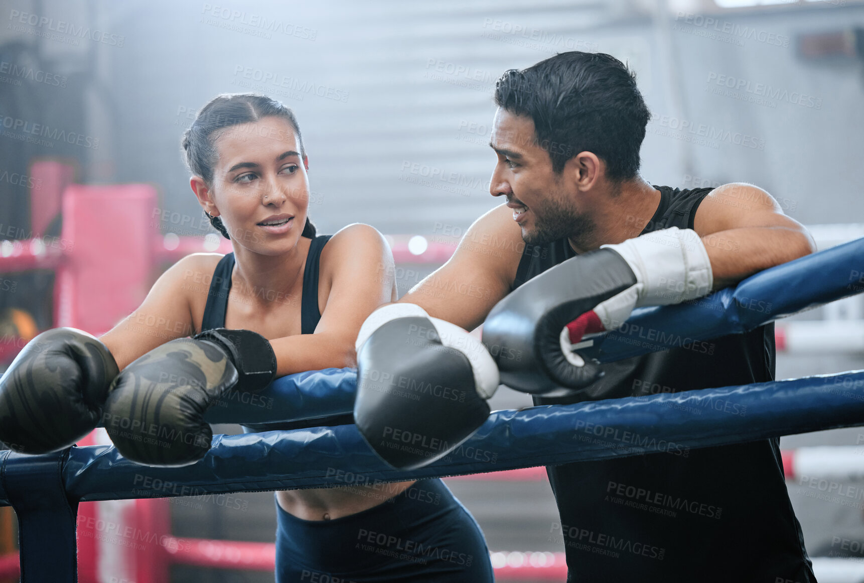 Buy stock photo Fit, active and healthy boxing team bonding after workout, training and exercise in a wellness center. Sporty, athletic or strong man and woman on break from kickboxing fight and sports match in ring