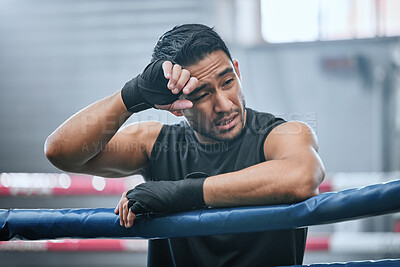 Fit, active and healthy boxing man tired, hot and wiping sweat in workout, training or exercise in wellness ring. Sporty, athletic or strong boxer upset after losing kickboxing fight or sports match