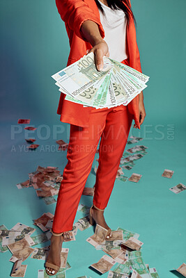 Buy stock photo Closeup of hands holding, showing and displaying money while standing against a blue studio background alone. One stylish, trendy and fashionable female donating or giving cash in a competition