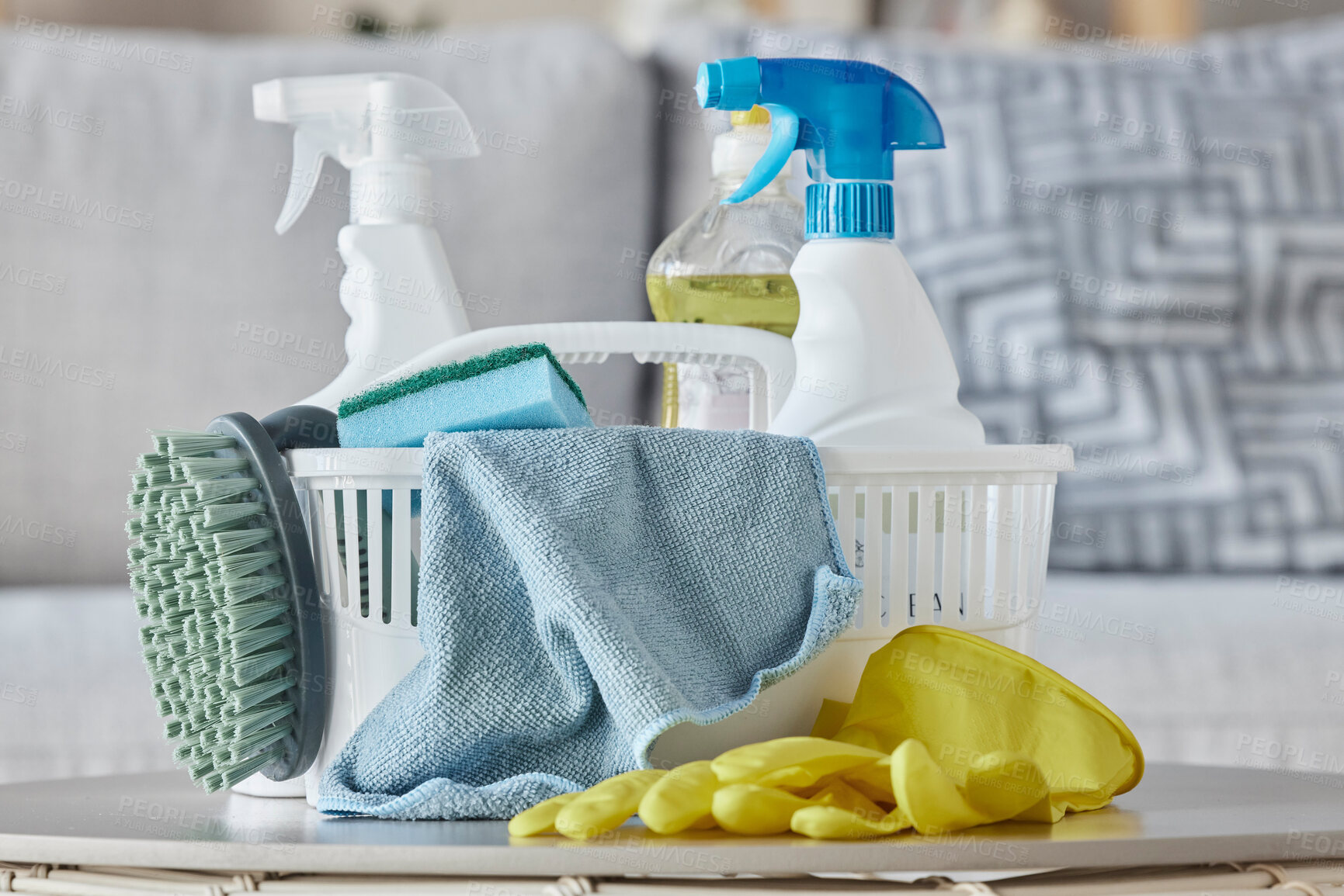Buy stock photo Cleaning products, brush and basket on table in home living room for housekeeping. Hygiene, spring cleaning and cleaning supplies, gloves and chemicals for disinfection, germs or bacteria prevention.