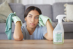 Tired, woman in home or spray bottle with cloth, mental health or exhausted with cleaning. Hispanic female, cleaner and sad maid in living room, rag or disinfectant with depression, stress or anxiety