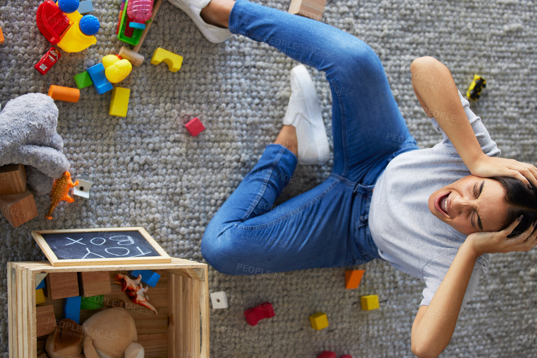 Buy stock photo Tired, stress and frustrated mom with fatigue and headache cleaning children toys. Above view of mama and woman scream from kids mess in a home living room feeling overwhelmed burnout from motherhood