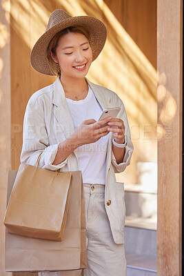 Buy stock photo Woman, shopping bag and phone for communication, ecommerce and online chat about sale, discount and savings while outdoor. Happy customer or asian female with smartphone for banking and retail coupon