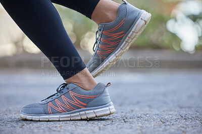 Buy stock photo Legs, shoes and woman running on road for health, wellness and exercise. Fitness, sports and healthy female athlete with sneakers training alone outdoors in town, street or city for race or marathon.
