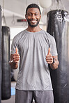 Thumbs up, fitness or black man for wellness lifestyle, exercise or positive mindset in sport gym. Thank you, support or happy personal trainer for workout motivation, success training or health goal
