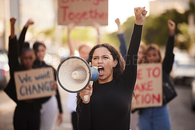 Buy stock photo Woman, megaphone and fist in community protest for change, gender based violence or equality in the city. Angry women activist standing together in march strike for human rights or government action