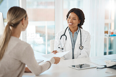 Buy stock photo Doctor and patient discuss paperwork during medical consultation in a hospital. Healthcare professional, GP or physician prepare insurance document and checking personal information at a clinic