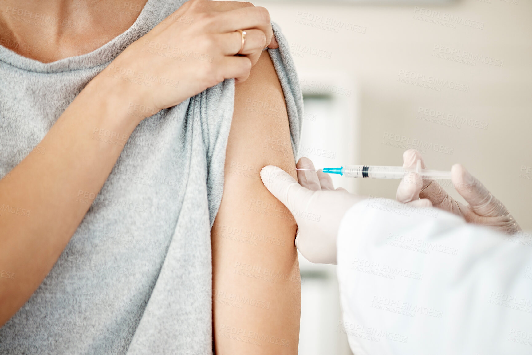 Buy stock photo Vaccine, injection and virus cure for covid, disease and pandemic illness from doctor, healthcare or medical professional. Closeup hands, arm and needle or syringe being injected into female patient