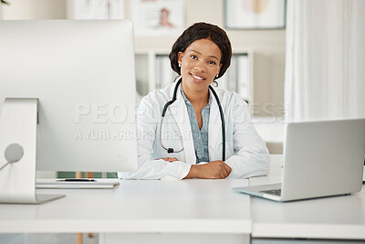 Buy stock photo Medical doctor working on laptop and desktop computer, networking with people online and sitting at a desk at a hospital. Portrait of a black female professional healthcare worker in office at clinic
