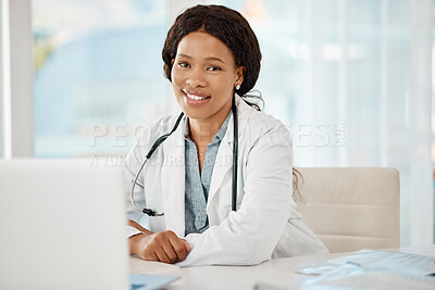 Buy stock photo African medical doctor working at a hospital, planning on a laptop and sitting at a desk in an office. Portrait of a black female professional, expert and happy healthcare worker smiling at a clinic