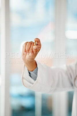 Buy stock photo Hand holding medicine, tablet and healthcare doctor holding a pill for remedy, cure for sickness and medication for good health. Closeup of a medical professional showing a vitamin or supplement