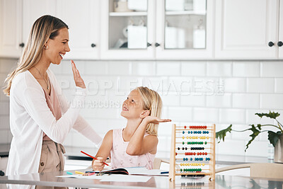 Buy stock photo Family, education and learning mother gives high five to young student, girl with school or math work in kitchen. Mom celebrates and support little child after working on class task with success