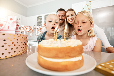 Buy stock photo Birthday, cake and celebration with a girl and her sister blowing out candles and making a wish with her family in the background. Celebrating, party and growing up with children and their parents