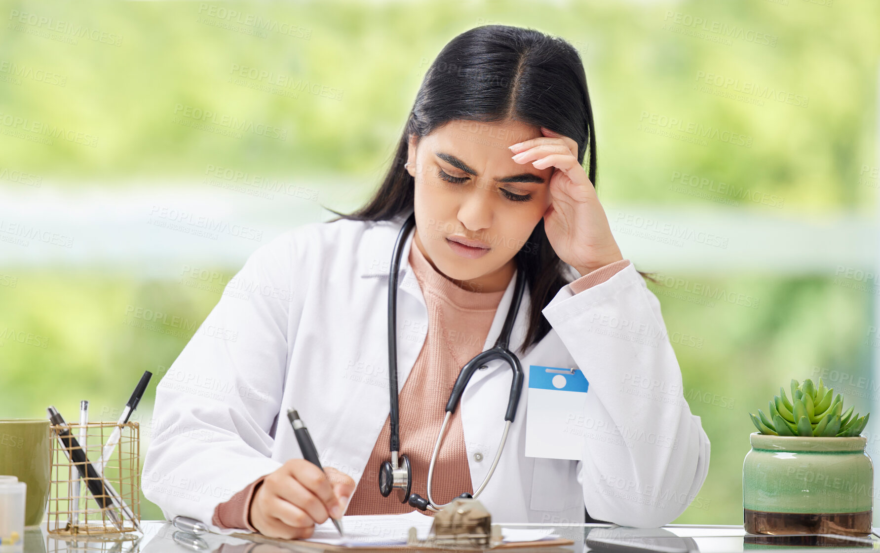 Buy stock photo Stress, anxiety and worry of a busy working woman doctor writing patient, medical and hospital data. Female healthcare professional burnout feeling stressed from a work headache and report deadline