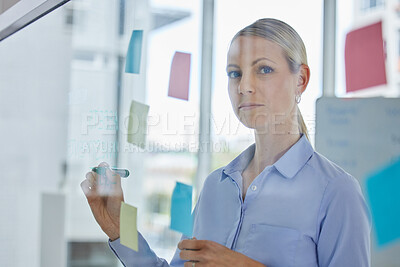 Buy stock photo Planning strategy, company vision and business idea in an office. Portrait of woman leader, analytics employee and logistics manager writing corporate schedule with post it on glass for innovation