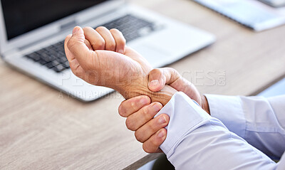 Buy stock photo Business man with bad wrist pain in the hand after an injury and ache while in the office. Closeup of a corporate male with a painful strain, hurtful and sore sitting at his desk