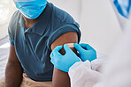 Medical doctor, registered nurse or healthcare professional placing plaster on arm after injecting covid vaccine. Closeup of patient treatment for disease or flu shot. Work in hospital or clinic.