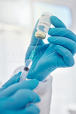 Buy stock photo Medical doctor holding covid vaccine, giving injection during checkup and preparing needle for consultation. Closeup of the hands of a healthcare worker, expert or professional working at hospital