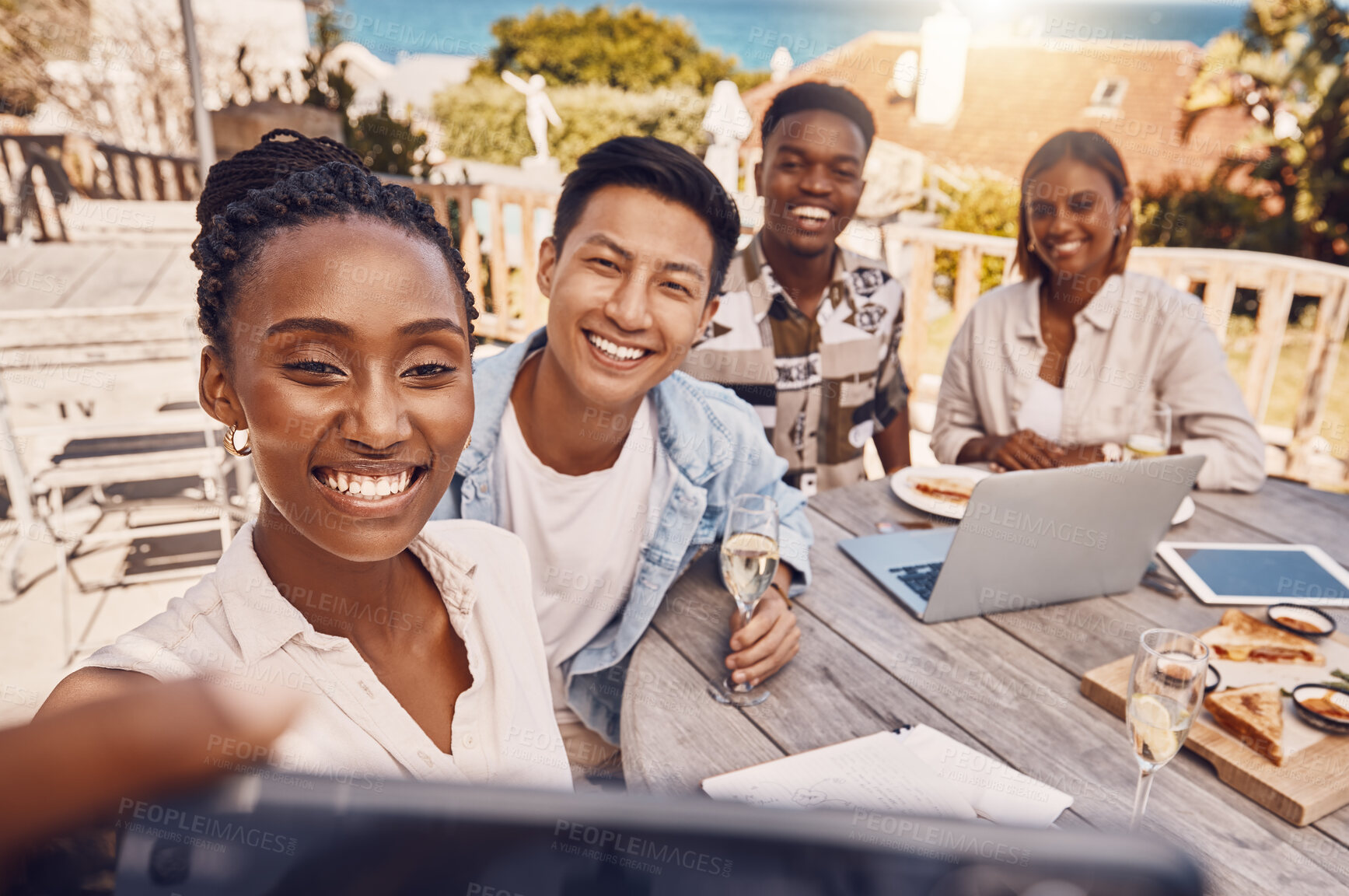 Buy stock photo Group of business people taking a selfie at a restaurant having a lunch meeting outdoors in a city. Colleagues or friends take a picture or a photo while on a break from work having brunch at a cafe