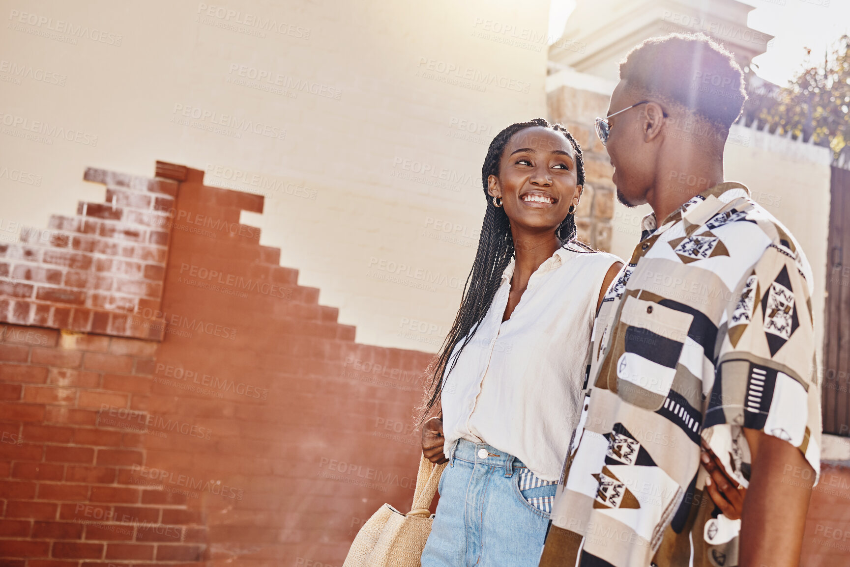 Buy stock photo Happy, love and relax couple walking in city on a date together on their getaway break. Summer, travel and smile with young black man and woman holding hands in the street of their vacation trip