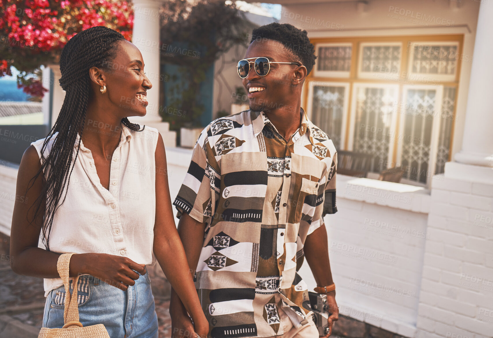 Buy stock photo Happy, relax and in love couple walking in small town or city street on their holiday date in spring time. Travel, summer  and smile man and woman holding hands on tourism vacation trip