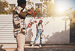 Photographer with model for summer fashion photography taking photo, posing and smiling for portrait shot with lens flare. African creative freelancer taking picture of young influencer woman outside