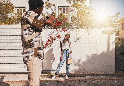 Buy stock photo Photographer with model for summer fashion photography taking photo, posing and smiling for portrait shot with lens flare. African creative freelancer taking picture of young influencer woman outside