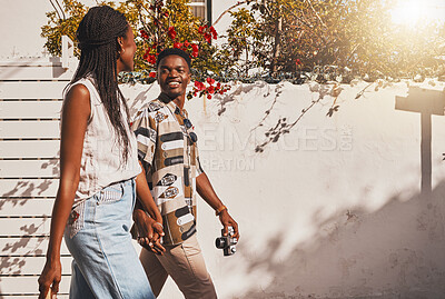 Buy stock photo Young love couple walking in summer, sun and fresh outdoor air together in neighborhood with lens flare. Happy, smile and content black people holding hands to relax, support and enjoy quality time 
