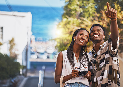 Buy stock photo Photographer couple on summer vacation or holiday abroad and tourism with lens flare, ocean and street background. Black people, man and woman looking at tourist destination for travel photography