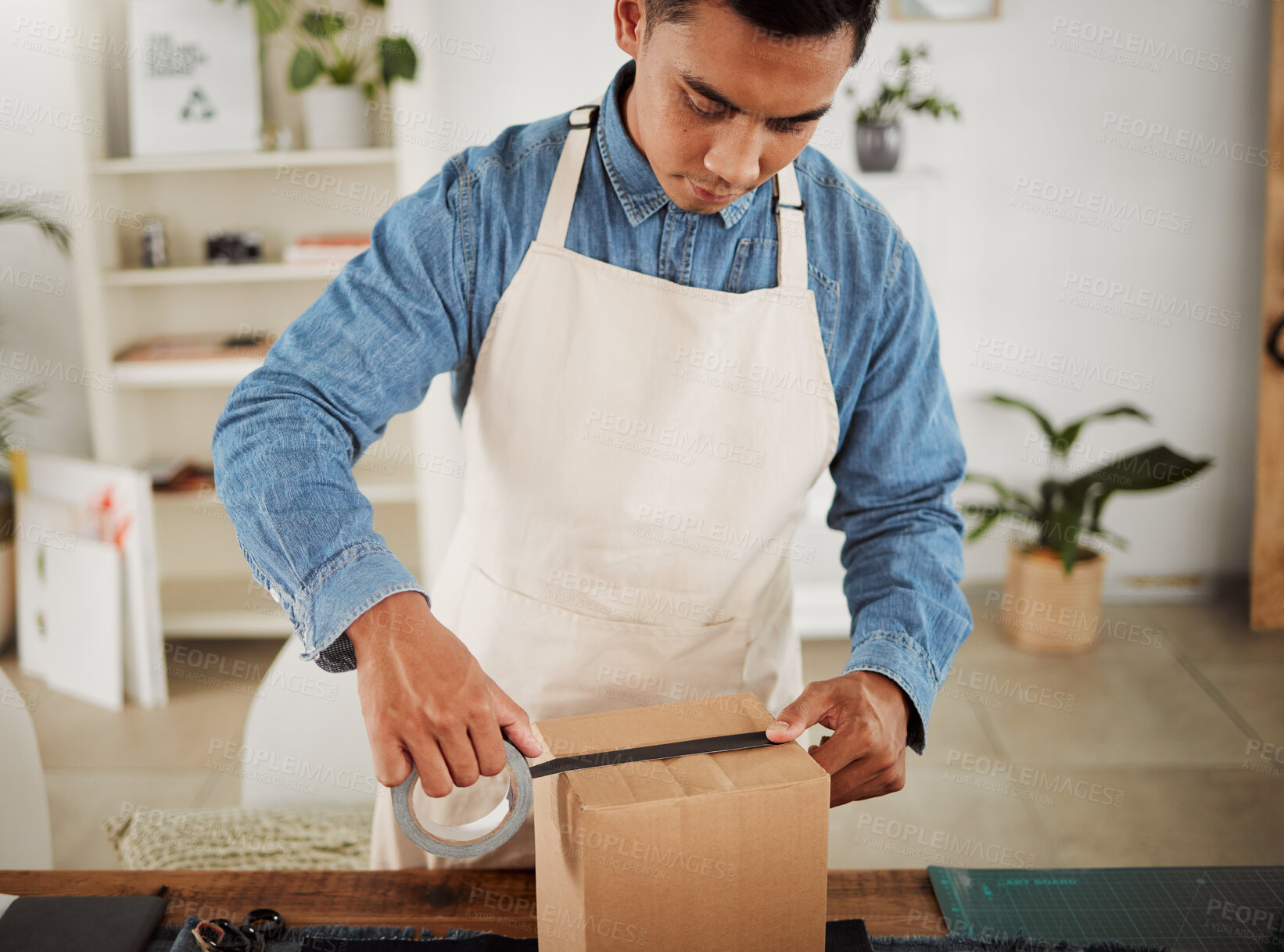 Buy stock photo Creative tailor closing order for shipping, seamstress packing product in a box for delivery and designer preparing a package at a shop. Male business owner, employee and courier working in a studio