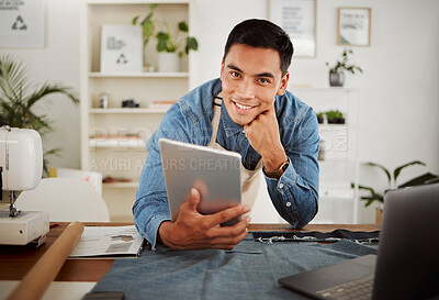 Buy stock photo Looking for fashion design ideas on tablet, planning creative clothing and working on website online while in a factory at work. Portrait of smiling designer, stylist or tailor at a shop for clothes