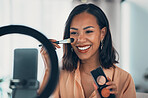 Beauty influencer, vlogger or podcast host teaching with a phone to film live stream makeup tutorial with blush makeup brush and palette. Happy woman use technology to promote cosmetic product online